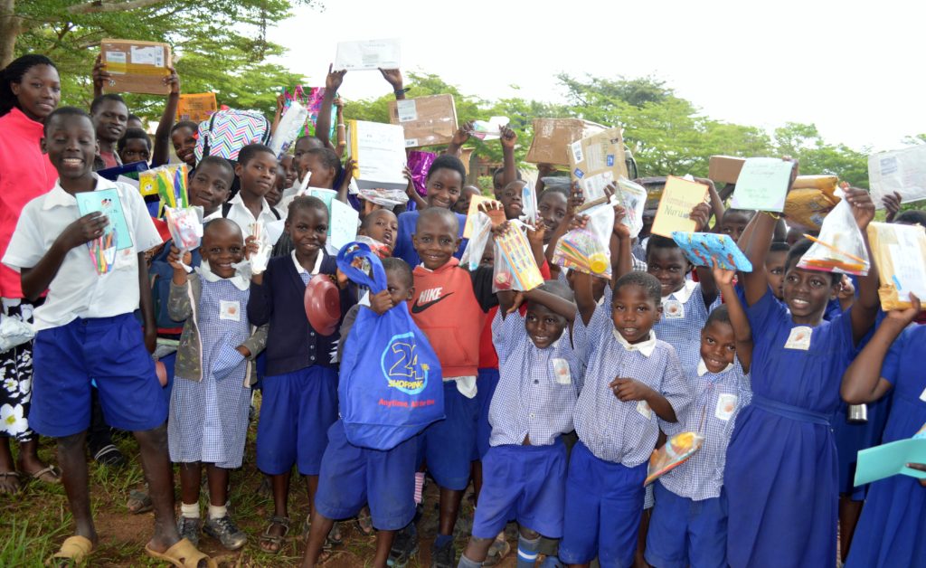 Excited children displaying the Christmas packages they had just received