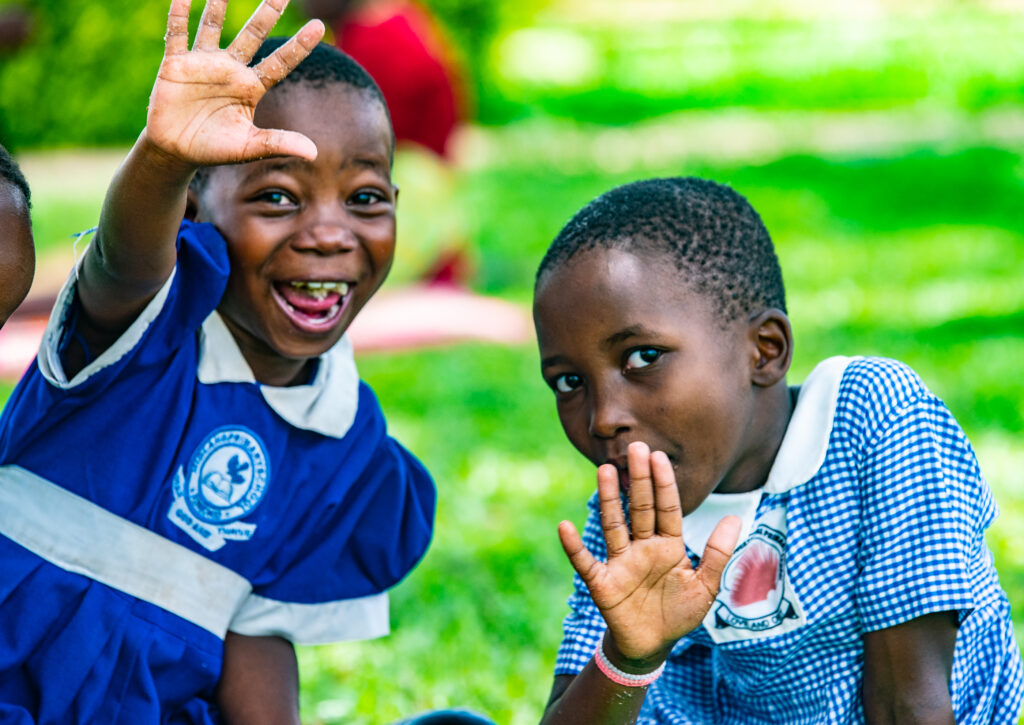Ugandan children waving hello
